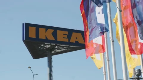 IKEA flags waving in the wind against sky and signboard, July 2022, Prague Stock Footage 203859690