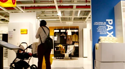 IKEA high speed  motion view Young mother chooses furniture for a new home Stock Footage 60696265