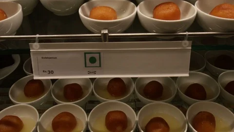 Ikea-Restaurant-Indian-sweets-gulab-jamun Stock Footage 94399210