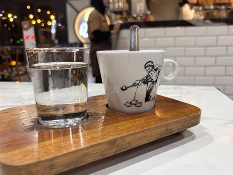 Ikely coffee or tea, presented on a rustic, rectangular wooden tray. Stock Photos