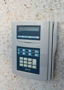 IKUSI time clock attendance system with keypad mounted on office Stock Photos