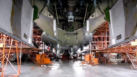 Il-76 aircraft (Candide) is mounted on hydraulic lifts. Release of landing gear. Stock Footage 124191850