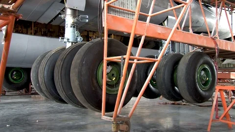 IL-76 aircraft is on hydraulic elevators. Maintenance of landing gear. Stock Footage 108802462
