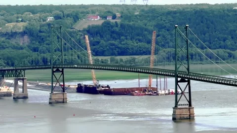 Île d'Orléans Bridge spanning across the river with construction cranes below. Stock Footage 346012040