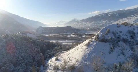 Île Falcon appearing between hills - Aerial 4K Stock Footage 83684833