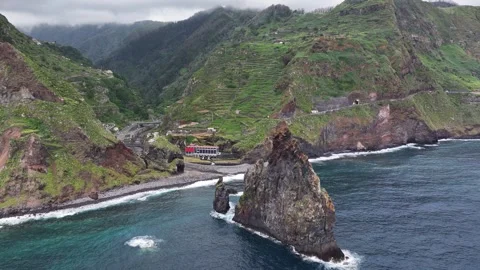 Ilhéus da Ribeira da Janela volcanic sea stacks off Madeira coastline, aerial Stock Footage 321704716