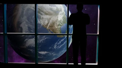 Ilhouetted man overlooking the Earth from space. Stock Footage 112892172