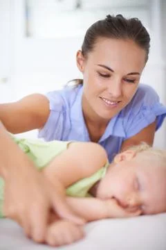 Ill always watch over you. a mother watching over her sleeping child. Stock Photos