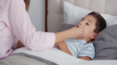 An ill boy feel weakness, takes medicinal drops orally and lies in the bedroom Stock Footage 255674039