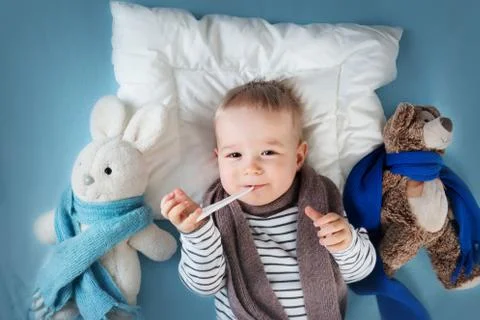 Ill boy lying in bed Stock Photos