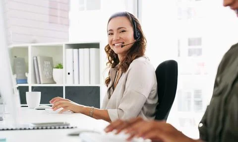 Ill do my best to help resolve any issues. a young woman using a computer and Stock Photos