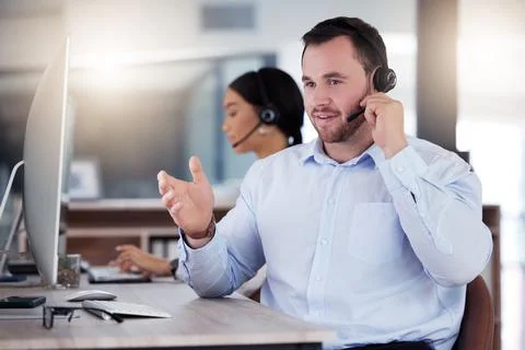 Ill explain it again for you. a young call centre agent working in an office at Stock Photos
