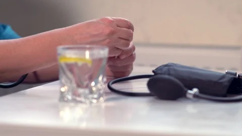 Ill man replacing a thermometer and taking pills Stock Footage 125895992