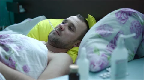 Ill Man Taking Temperature and Coughing Stock Footage 60376544