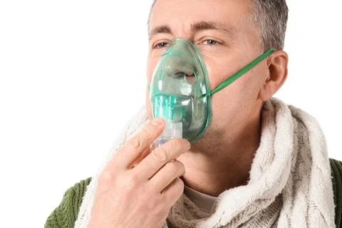Ill mature man using nebulizer on white background, closeup Stock Photos