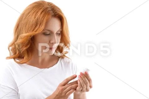 Ill middle-aged lady holding pills Stock Photos