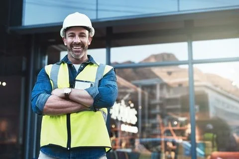 Ill take on any challenge. a engineer standing in front of a building. Fotos de archivo