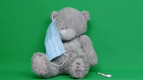 Ill teddy bear. An ill teddy bear wear a medical mask on it face. Chroma key Stock-Footage 126861096