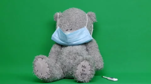 Ill teddy bear. An ill teddy bear wear a medical mask on it face. Chroma key Stock-Footage 126861441