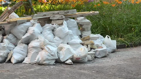 Illegal Construction Waste Dump Beside Blooming Flowerbed: Parallax Shot Vidéo 338209338