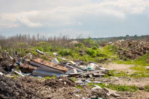 Illegal  dump garbage. Trash pollution in the nature. Stock Photos