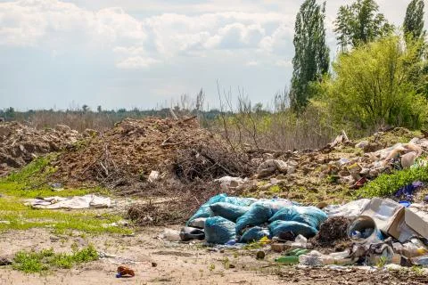 Illegal  dump garbage. Trash pollution in the nature. Stock Photos