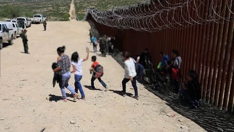 Illegal immigrants surrender to Border Patrol Agents at Sasabe on Mexican border Stock Footage 109538061