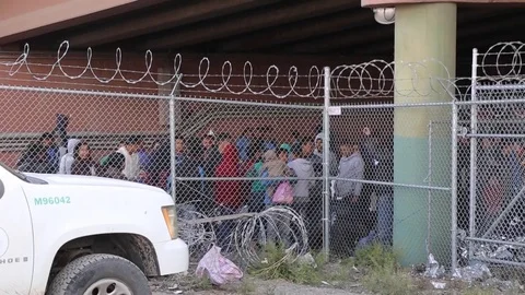 Illegal migrants behind a barbed wire fence 1 Stock Footage 109170547