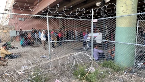 Illegal migrants behind a barbed wire fence 2 Stock Footage 109171681