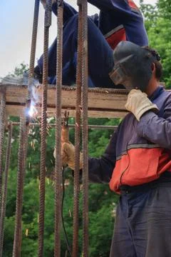 Illegal migrants working in construction as a welder Stock Photos