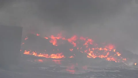 Illegal oil storage warehouse on fire, a lot of thick black smoke, air pollution Stock Footage 154876230