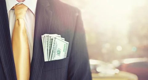 Illegal proceeds in his pocket. Cropped shot of a businessman with money in his Stock Photos