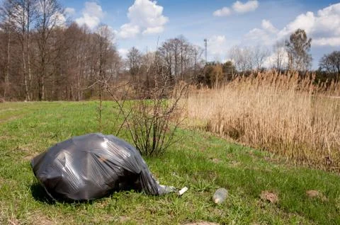 Illegal scatter garbage in black plastic bag Stock Photos