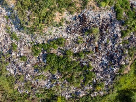 Illegal storage of solid household waste, plastic bottles and garbage bags. Land Stock Photos