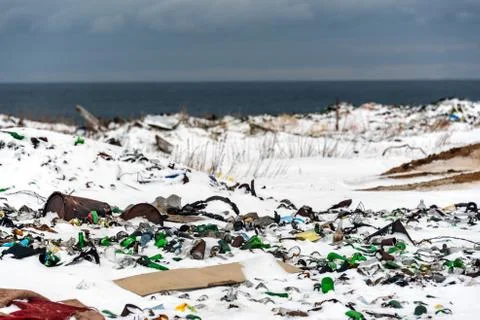 Illegal trash dump in the Arctic snow polluting the pristine environment Stock Photos
