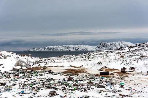 Illegal trash dump in the Arctic snow polluting the pristine environment Stock Photos