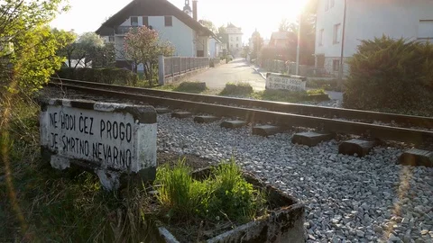 Illegally crossing train tracks despite warning signs Stock Footage 128284903