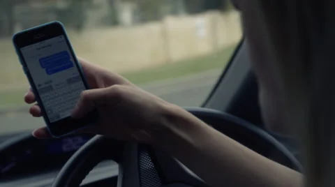 Illegally Iphone text message whilst driving a car Stock Footage 65243153