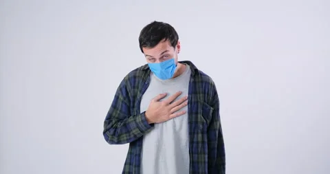 Illness Man coughing in protective face mask and covering mouth in slow motion 库存影片 143943934