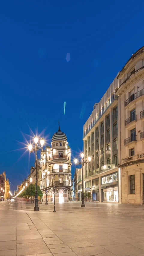 Illuminated Adriatica building, Constitucion Avenue, Seville at night Stock Footage 325038122