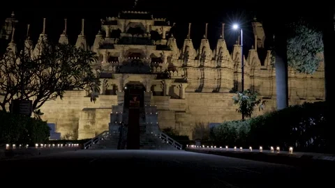 Illuminated ancient unique temple architecture with devotee at night from l.. Stock Footage 278476017