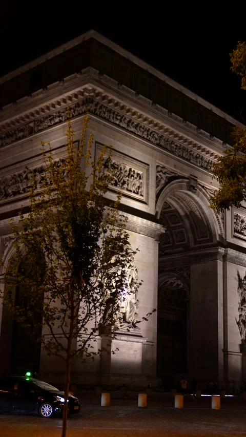 Illuminated Arc de Triomphe at night with traffic in Paris, France 06.08.2025 Stock Footage 310953669