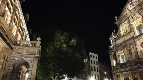 Illuminated baroque Saint Charles Borromeo Church facade and trees in Antwerp Stock Footage 300310020