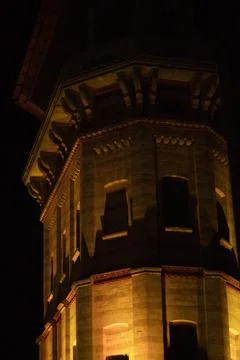 Illuminated from below a large stone tower in the dark Stock Photos