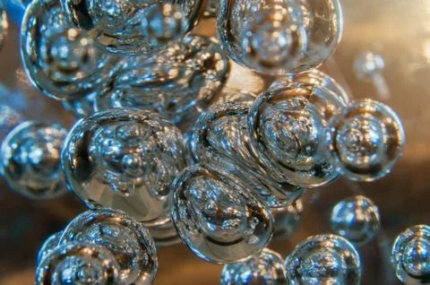 Illuminated Bubbles Floating in Clear Environment with Warm Sun Glow. Foto stock