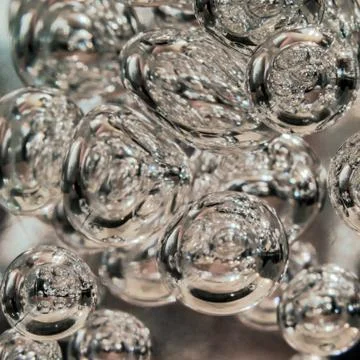 Illuminated Bubbles Floating in Clear Liquid. Abstract Background Texture. Stock Photos