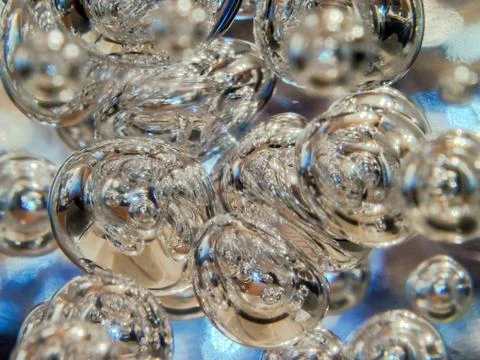 Illuminated Bubbles Floating in Clear Liquid. Abstract Background Texture Stock Photos