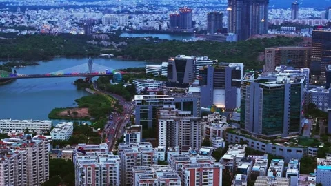 Illuminated cable bridge with Durgam Cheruvu, skyline, corporate building and Video stock 341075955