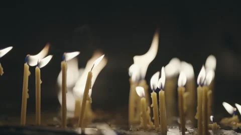 Illuminated candles of devotion invoke a sense of warmth and spirituality in  Stock Footage 329912552