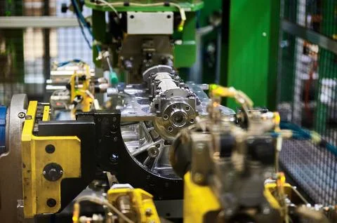 Illuminated car engine on test stand in production plant shop Stock Photos
